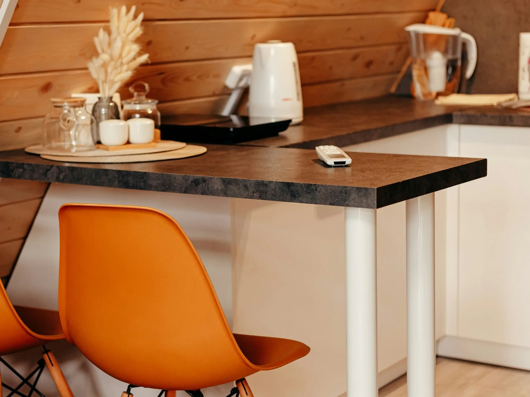 Warm wooden home kitchen with a table and two chairs
